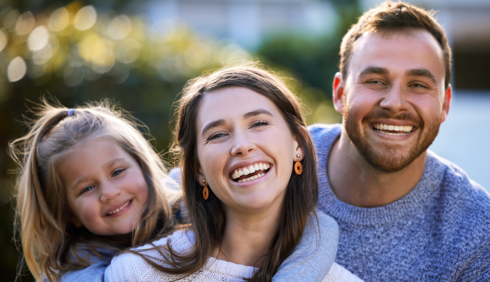 Happy family, parents and child in park for portrait or bonding together with funny joke, love or smile.