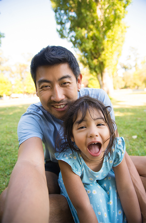 Asian dad taking selfie with his beautiful daughter.