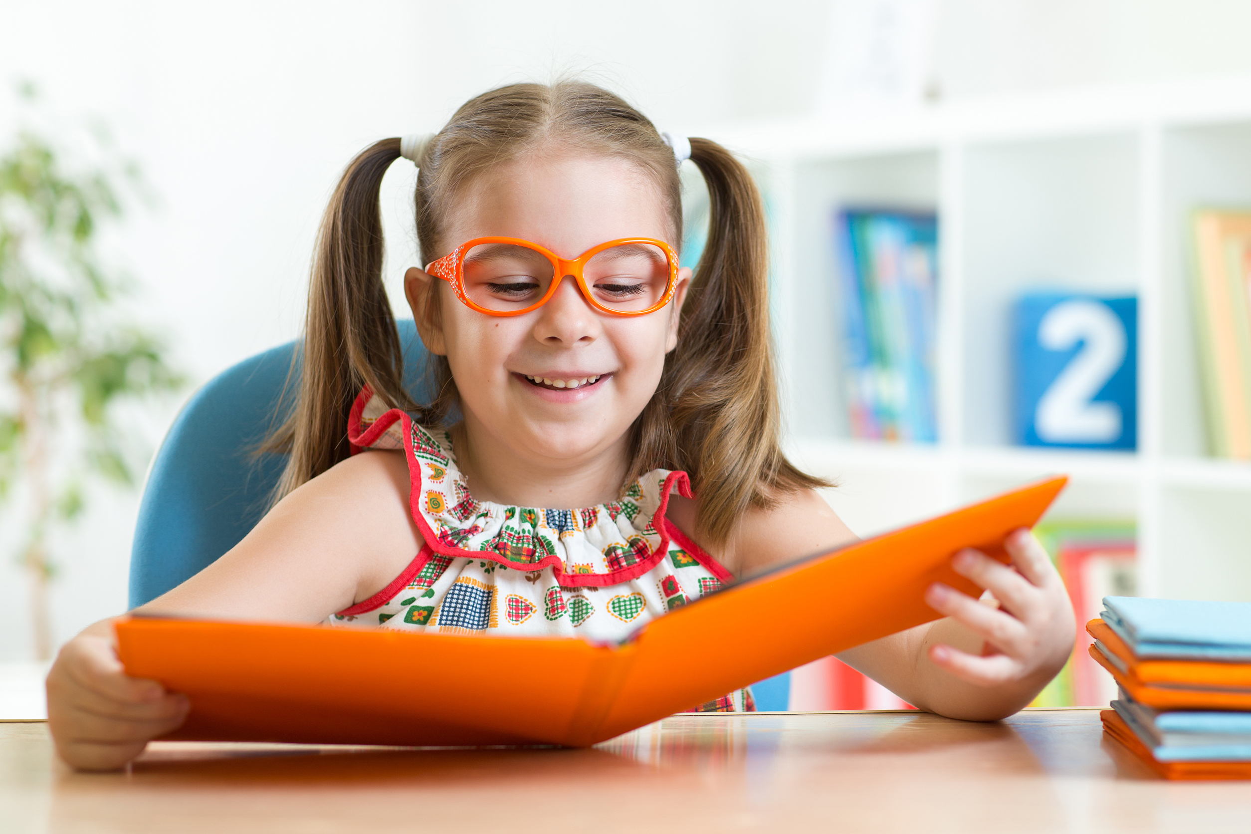 girl in eyeglasses reading a book