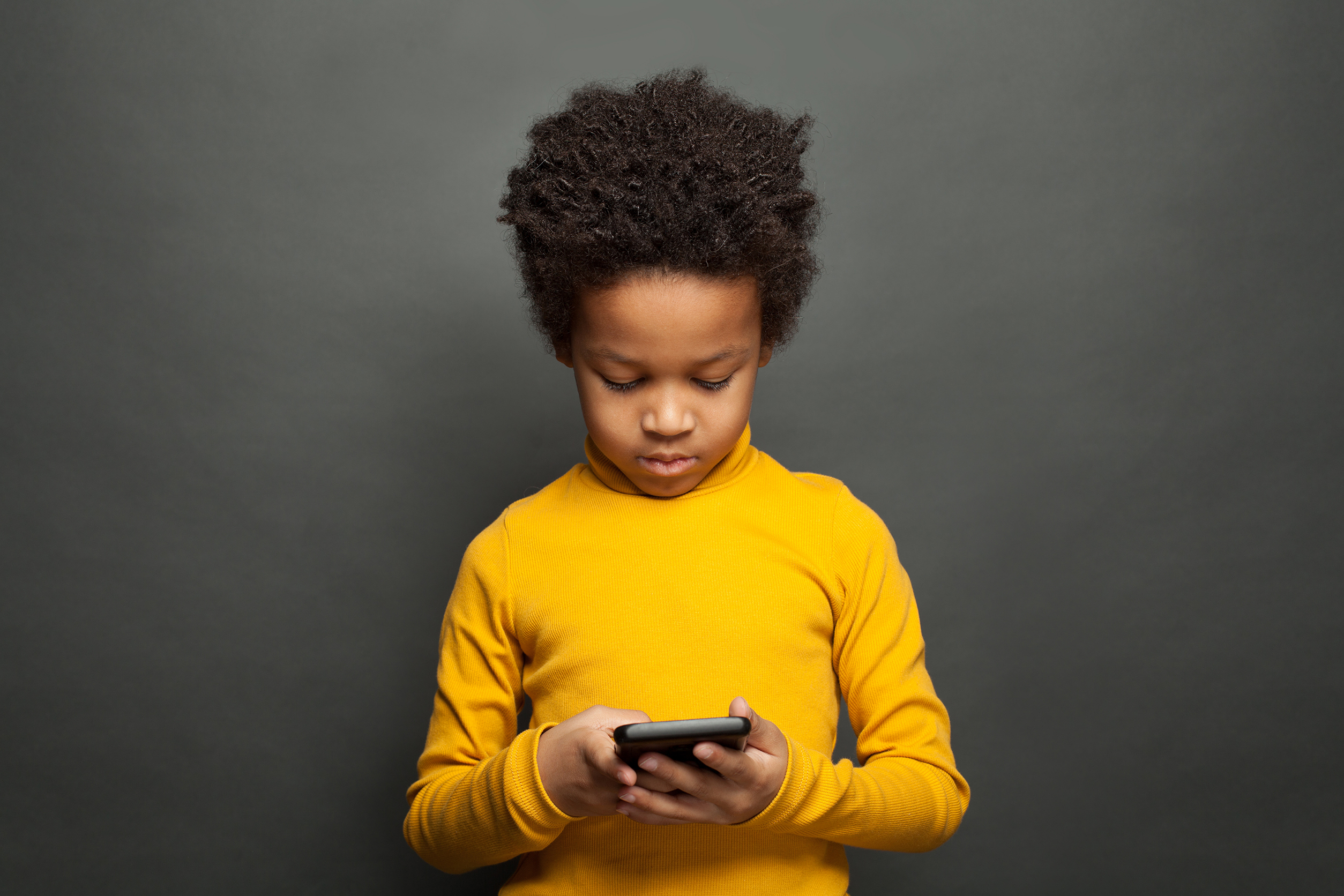 African American child using smartphone African American child using smartphone