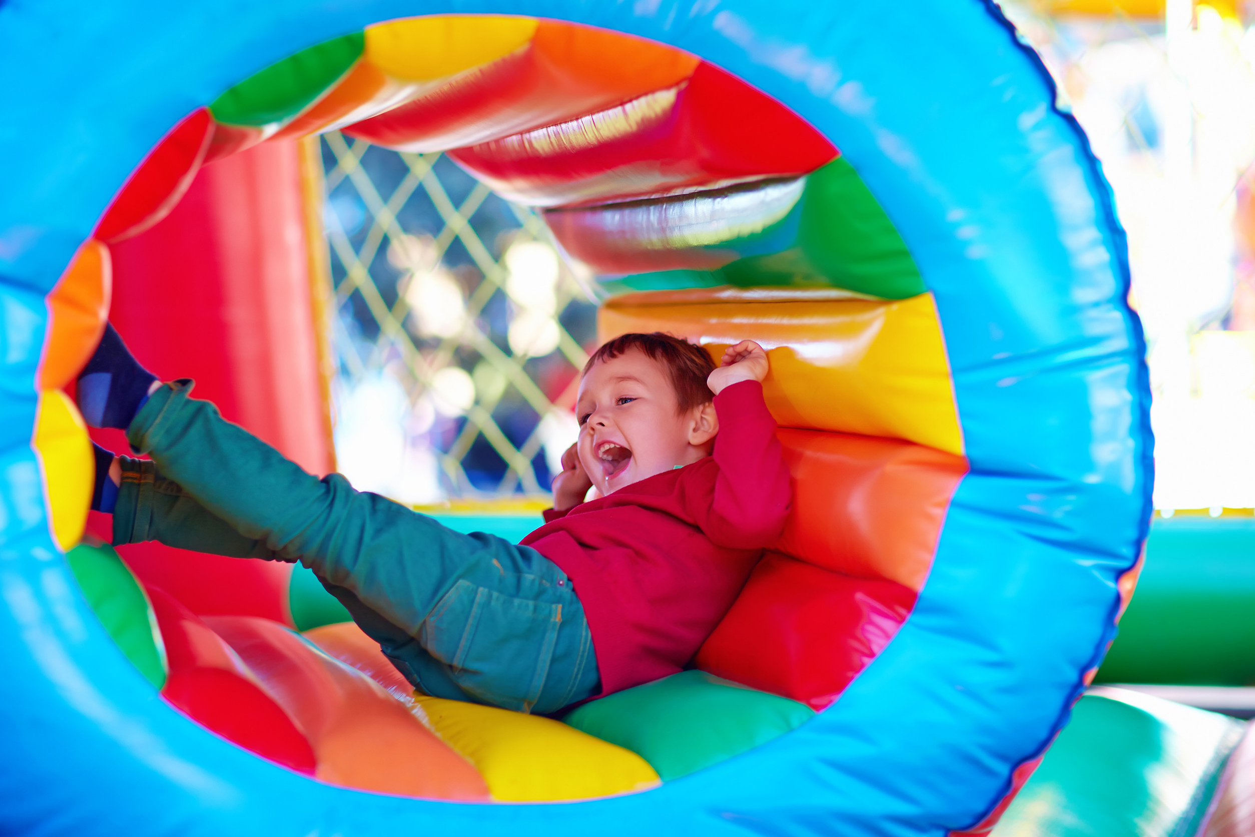 happy kids playing on inflatable attraction playground